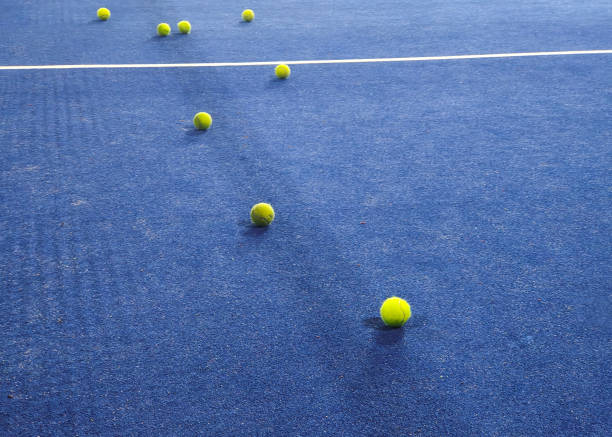 a heap of tennis balls on a green grass. Balls for popular sports game, accessory for competition