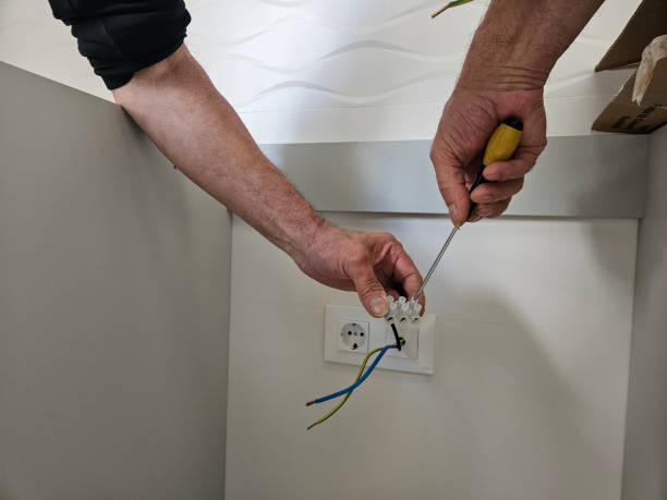 istock 60 years old plumber installing : electrician prepares ceramic hob plug, frame in hands 2148409639