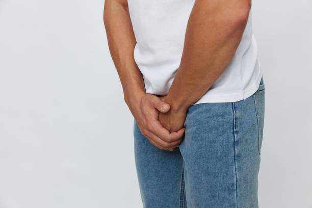 istock Man groin pain problems with potency and urination, urolithiasis, in white t-shirt on white isolated background, copy space 2148409899