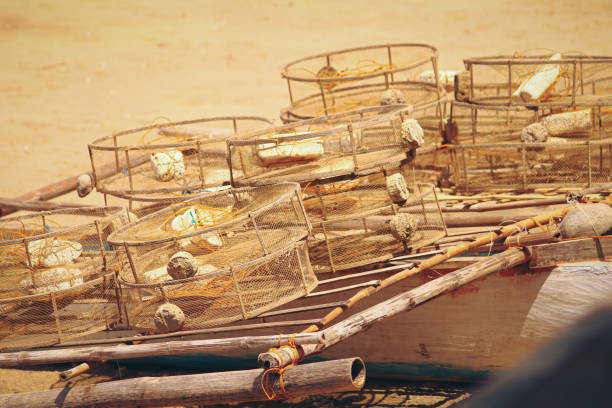 Traditional circular fish traps made from sturdy metal frame and plastic nets left to dry in the sun after being used showing the local source of food and income of the fishermen in the Philippines
