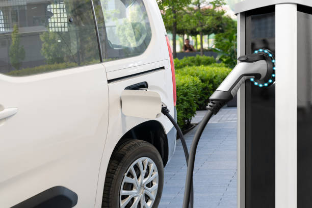istock Electric delivery van with electric vehicles charging station 2148410911
