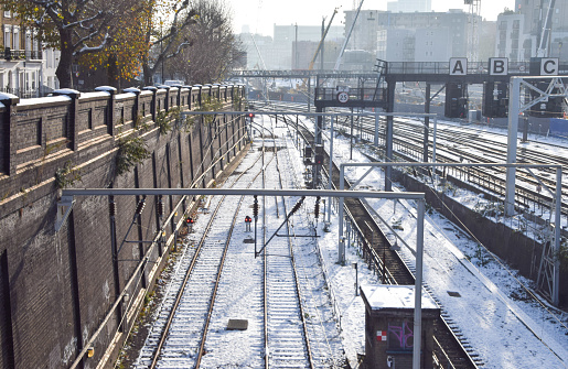 London, UK - December 14 2022: snow on train tracks in London.