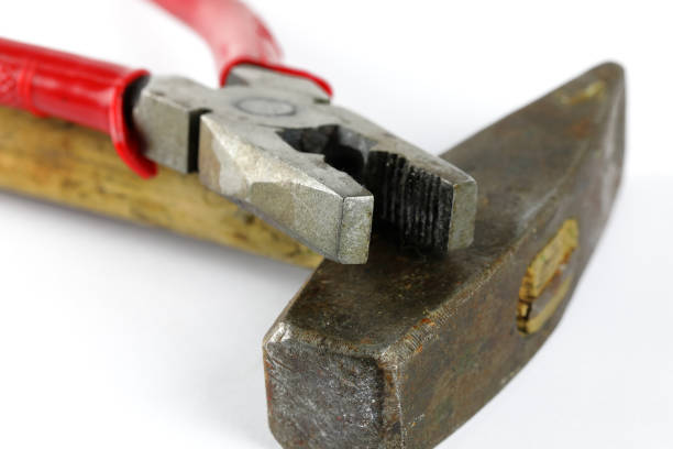 Two different, not very complicated, popular and very necessary tools for carrying out a wide range of jobs, a hammer and a pliers.