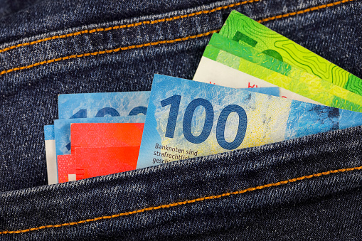 Banknotes sticking out of a pocket. This theme can be used to illustrate a wide range of financial topics. Swiss franc currency, CHF