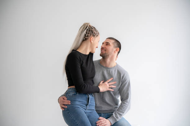 istock Joyful Couple Sharing a Laugh and fun Together at home against white wall 2148415847