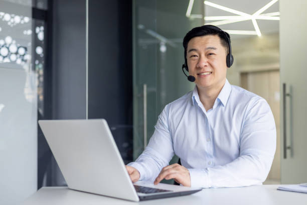 istock Smiling Asian businessman working in a modern office 2148416951