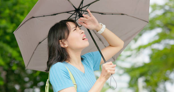 istock asian woman stand outdoors pain 2148417003