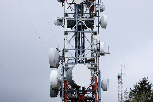 The tower stands tall with numerous antennas attached to it, serving as a hub for communication signals and data transmission. The antennas protrude in various directions, extending the reach of wireless networks and broadcasting capabilities.