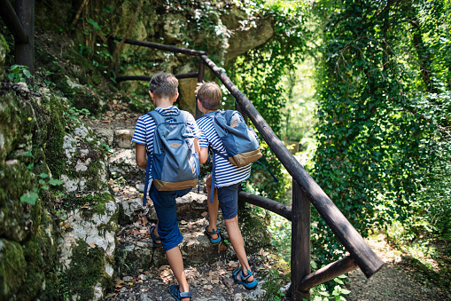 Family hiking in the mountains of Campania, Italy. Two cute little boys hiking on a rocky trail in mountains of Campania, Italy.\nShot with Nikon D850.