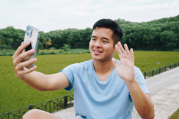 istock Young man on a video call at the park 2148419772