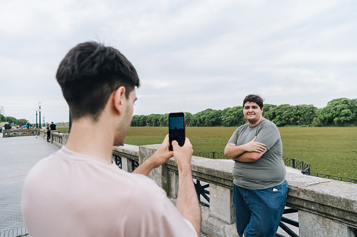 Young man taking selfie of friend at the park