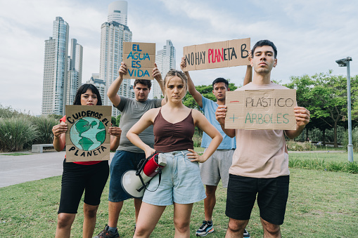 Portrait of people holding signs during on a demonstration for environmentalism outdoors