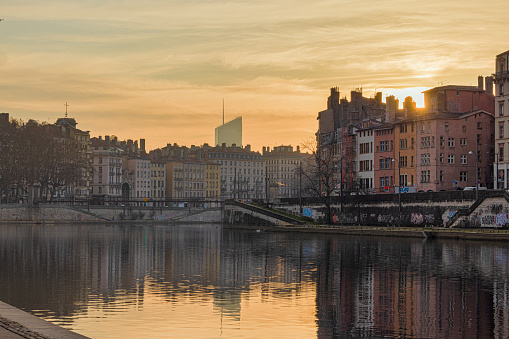 Sunrise on the quays of the Saône in Lyon with the sky reflecting in the Saône river