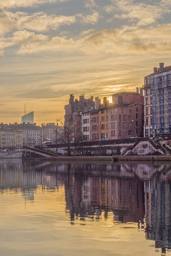 Sunrise on the quays of the Saône in Lyon with the sky reflecting in the Saône river