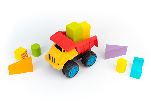 Top view of colorful wooden bricks on the table. Early learning. Educational toys on a white background. For the development of the child.
