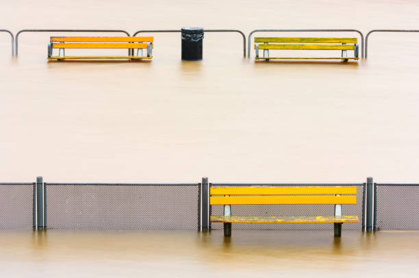 Benches at bus stop flooded with water
