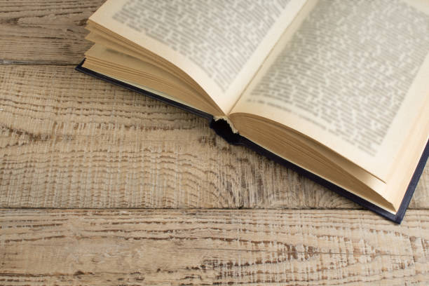 istock open book on a wooden table. Back to school. Education business concept. 2148426037