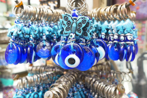 istock a bunch of blue evil eye keychains hanging on a shelf 2148426594