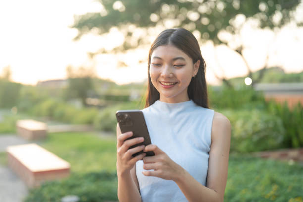 istock Content Young Woman Using Smartphone in Park. 2148427447