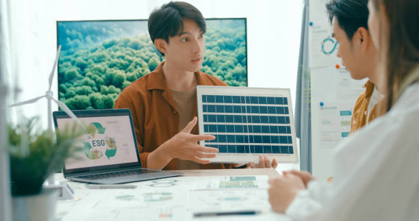 istock Diverse team collaborates on renewable energy solutions, with a focus on solar panel technology and sustainable business practices. Eco-Friendly Business Team Discussing ESG Goals. 2148427769