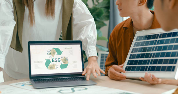 istock Closeup of diverse team collaborates on renewable energy solutions, with a focus on solar panel technology and sustainable business practices. Eco-Friendly Business Team Discussing ESG Goals. 2148427781