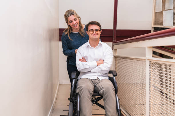 istock Warm Companionship: Supportive Woman Pushing Man's Wheelchair 2148428266