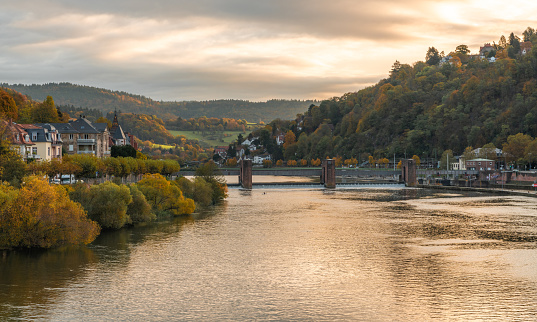 Beautiful morning view with warm colors on the riverbanks of the Neckar river. Beautiful historical city of Heidelberg in Germany. Beautiful touristic spot. Must-see spot in Germany. Wonderful view in German city Heidelberg.