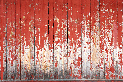 Texture of vintage wood boards with cracked paint of white, red, yellow and blue color. Horizontal retro background with old wooden planks of different colors