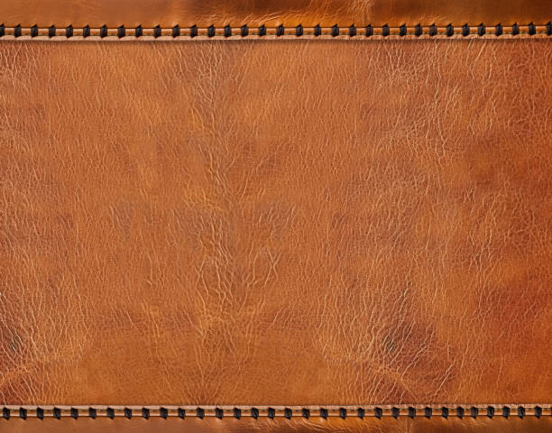 istock Horizontal or vertical leather background of brown colors with decorative braided edging. Decorative backdrop with cowhide texture and braided edge. Copy space for text 2148429196