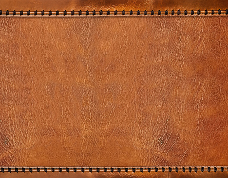 Horizontal or vertical leather background of brown colors with decorative braided edging. Decorative backdrop with cowhide texture and braided edge. Mock up template. Copy space for text
