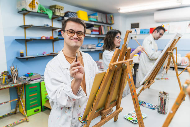 istock Confident Man with Down Syndrome Enjoys His Time in Art Class 2148429208