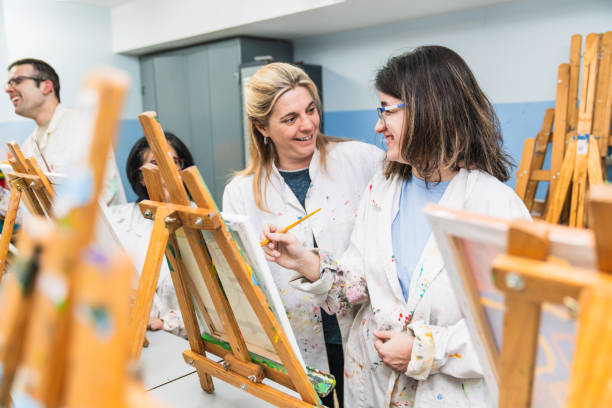 istock Teacher and Student with Disability Sharing a Moment in Art Class 2148429375