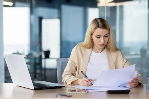 istock Professional woman working at a modern office desk 2148429789
