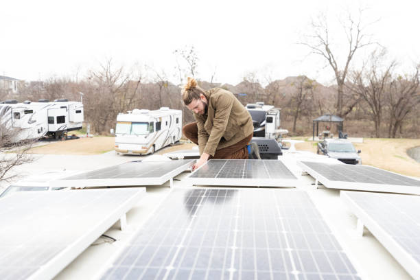 istock Environmentally conscious male millennial repairs solar panels on RV 2148430179