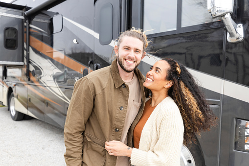 A young adult hipster couple enjoys their honeymoon travelling the US in their new RV.