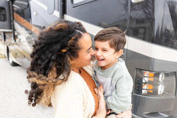 istock Standing by RV, mom and young son share laugh 2148430191