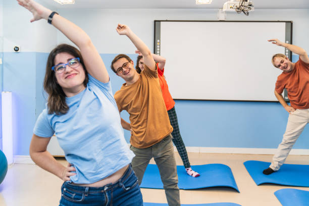 istock Energetic Group Stretching in a Special Needs Yoga Class 2148430318