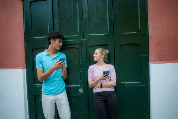istock Woman and man using cell phone outdoors 2148430745