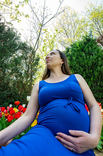 Beautiful pregnant  woman feeling lovely and smile in the park