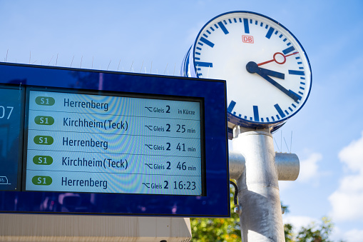 Kirchheim Teck, Baden-Württemberg, Germany, October 4 2023: Digital display board platform 2 for train S1, large clock at the station, time travel