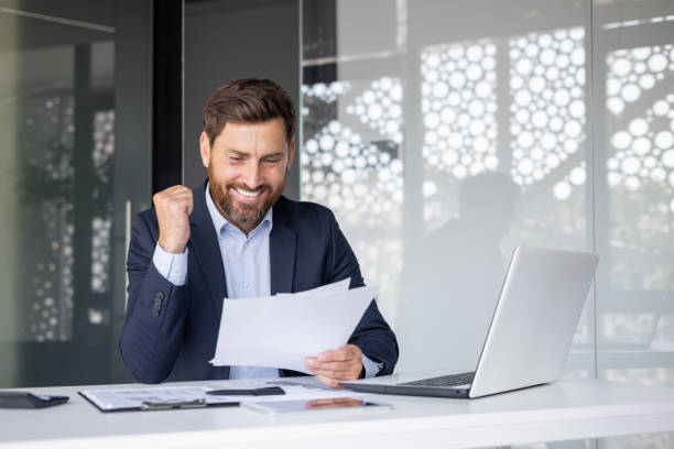 istock Successful businessman celebrating a triumph in office 2148433639