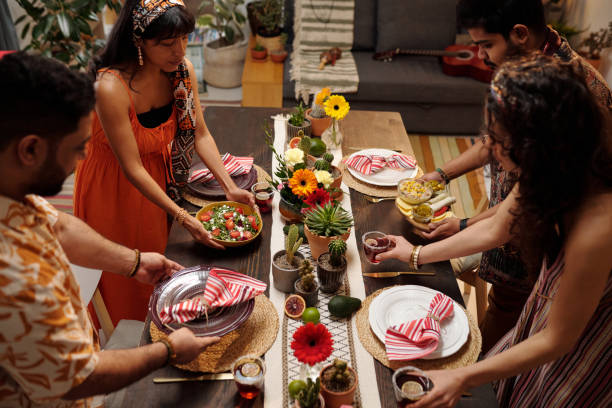 istock Friends putting food on festive dinner 2148435205