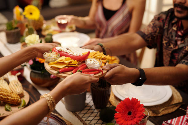 Hands of woman passing tray with snacks