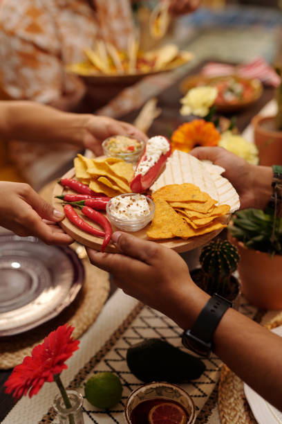 istock Male guest passing tray with nachos 2148435289