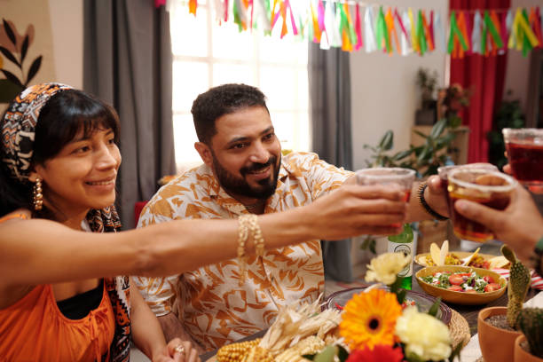 istock Happy young couple toasting with friends 2148435296