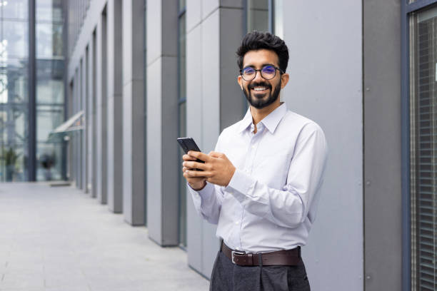 istock Professional man texting on smartphone in urban setting 2148435619