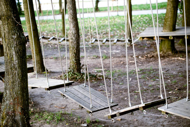 Outdoor activity with fun. Sport in the forest. A rope park is a rope structure mounted on trees or poles, used for safe fun at heights. This is the safest way to practice physical recreation similar to mountaineering. Rope parks provide unforgettable experiences, adrenaline and exercise in the fresh air. It is fun for children, teenagers, adults and older people.Various obstacles made of wood, steel ropes, plastic ropes or mesh are hung between the trees (or poles). The most common ones include hanging footbridges, beams suspended on cables, U-shaped cables, zip lines, net walks, and rope jumps.