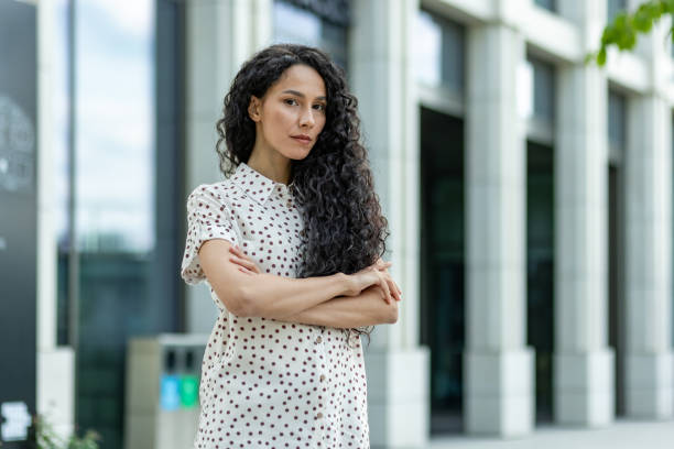 istock Confident businesswoman standing outside modern building 2148436548