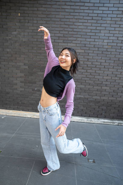 istock Playful Woman Balancing with Arms Outstretched. 2148436986
