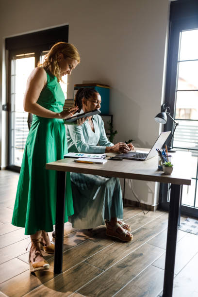 istock Two diverse businesswomen co-working on a mutual project 2148439252